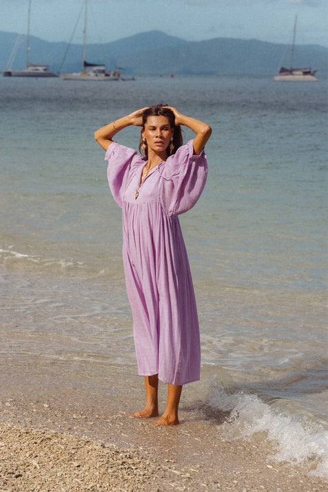 Daughters of India Kyra Midi Dress in Lilac Gauze — full length on beach with sailboats, billowed sleeves, cotton gauze