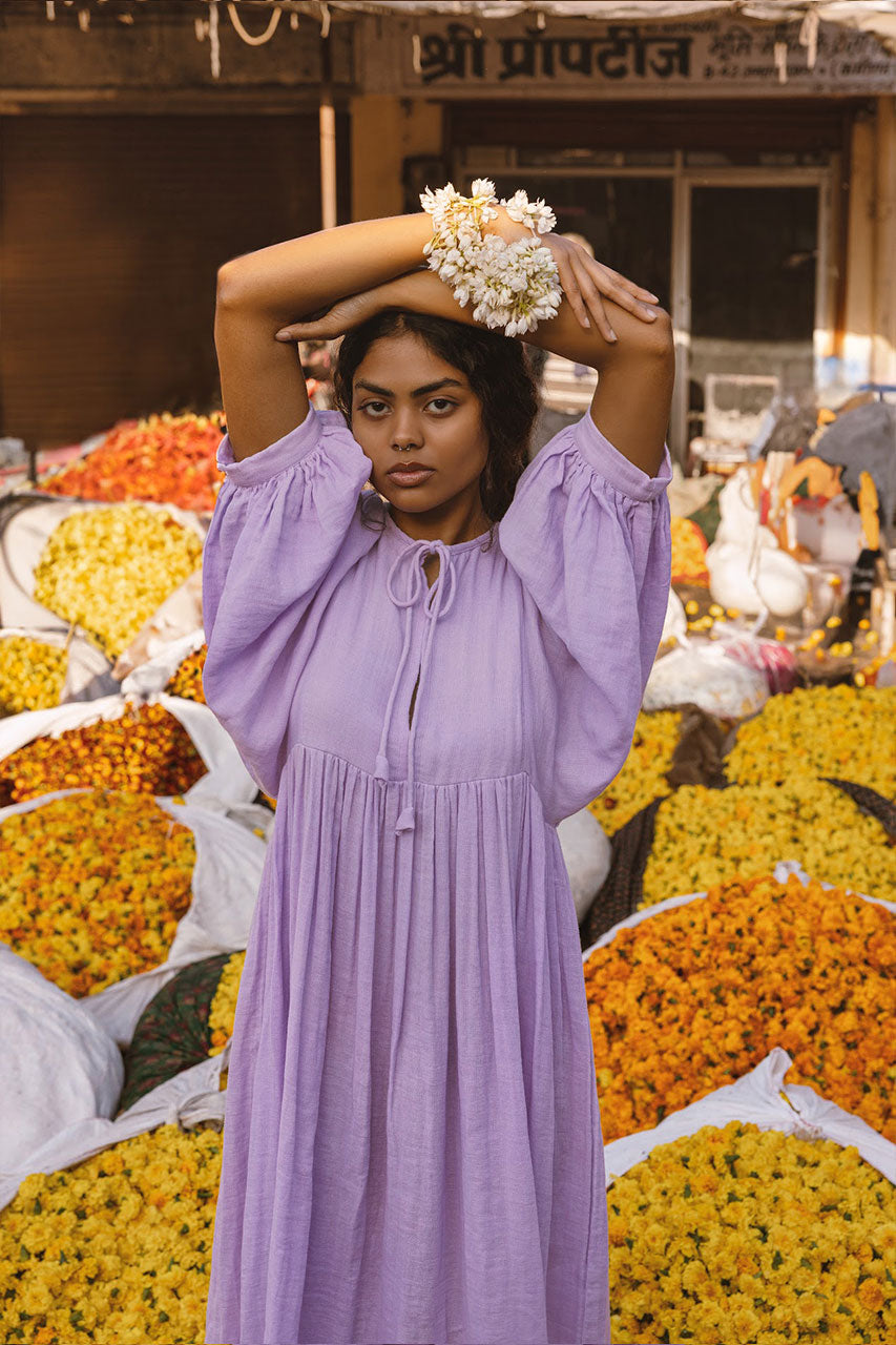 Daughters of India Kyra Midi Dress in Lilac Gauze — at flower market holding jasmine garland, billowed sleeves