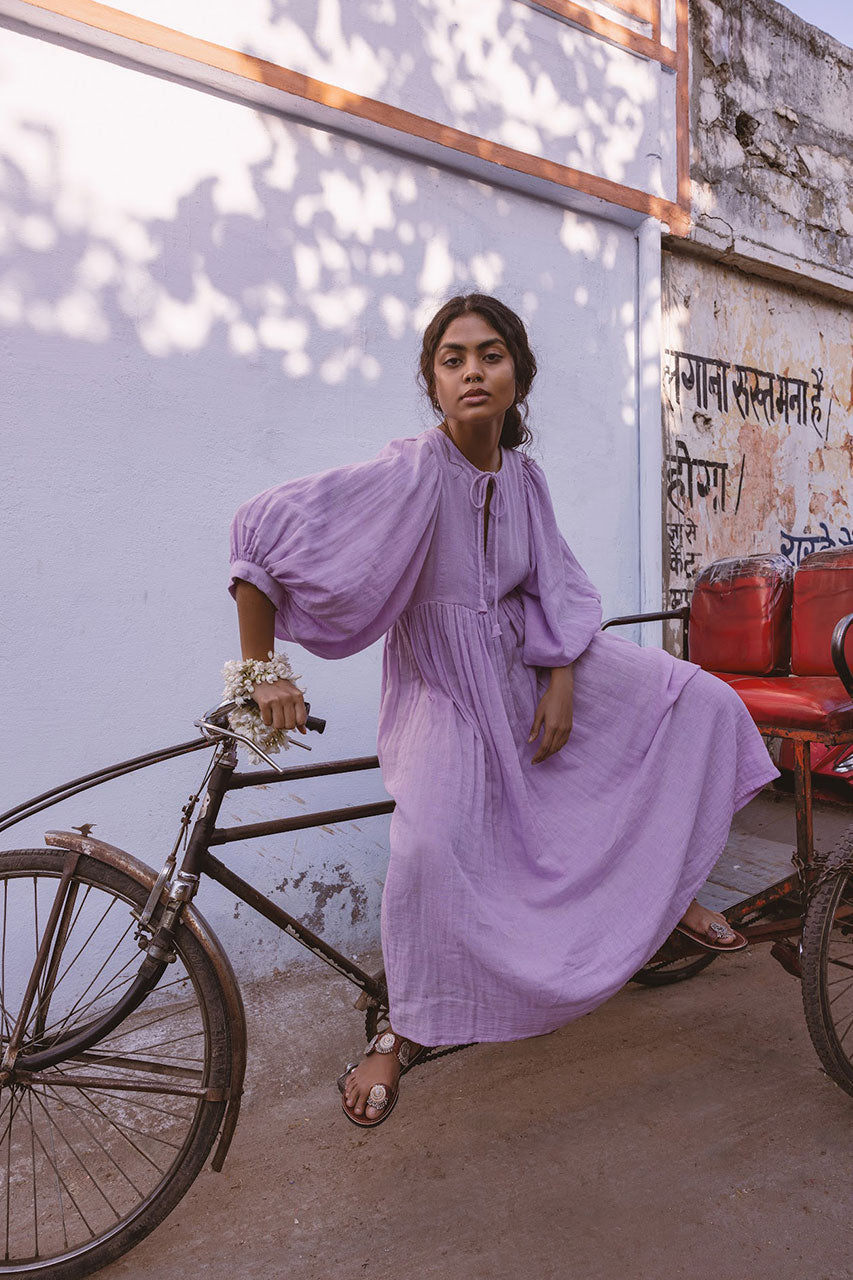 Daughters of India Kyra Midi Dress in Lilac Gauze — leaning on bicycle by Indian street wall, cotton gauze