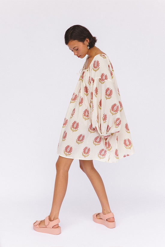 Ria Mini Dress Strawberry Cream — studio lower body detail, model wearing strawberry cream floral hand block print cotton mini dress with pink platform sandals, above-knee hemline styling, artisan Jaipur India | Daughters of India